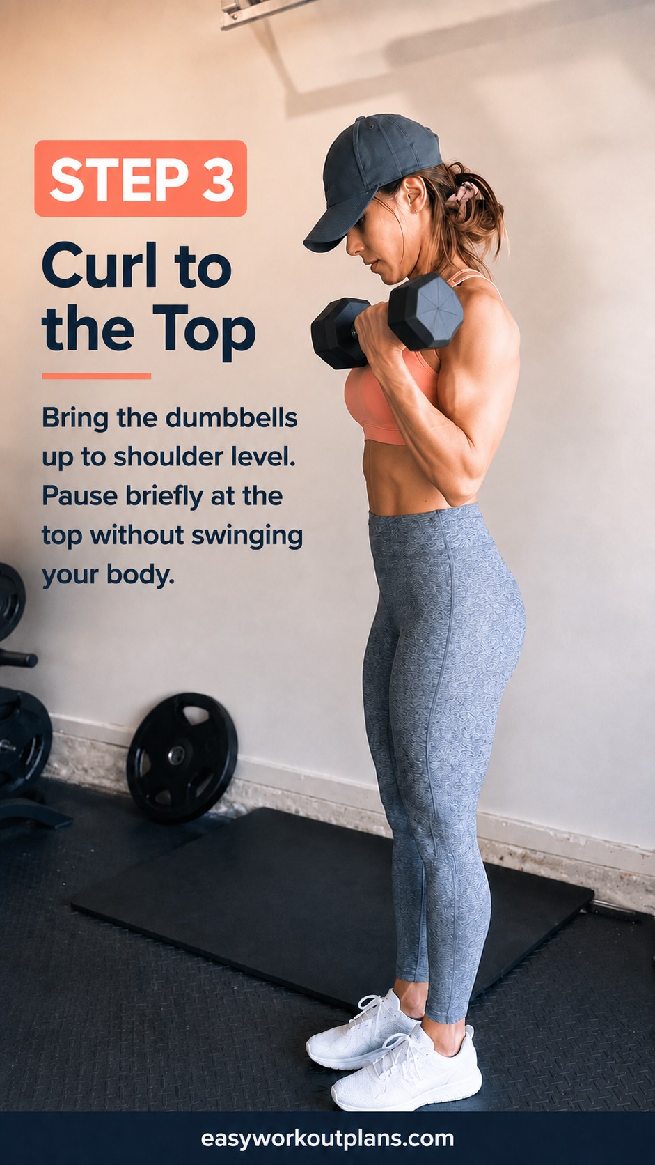 Dumbbells pause at shoulder height mid-curl during a controlled dumbbell arm workout set.