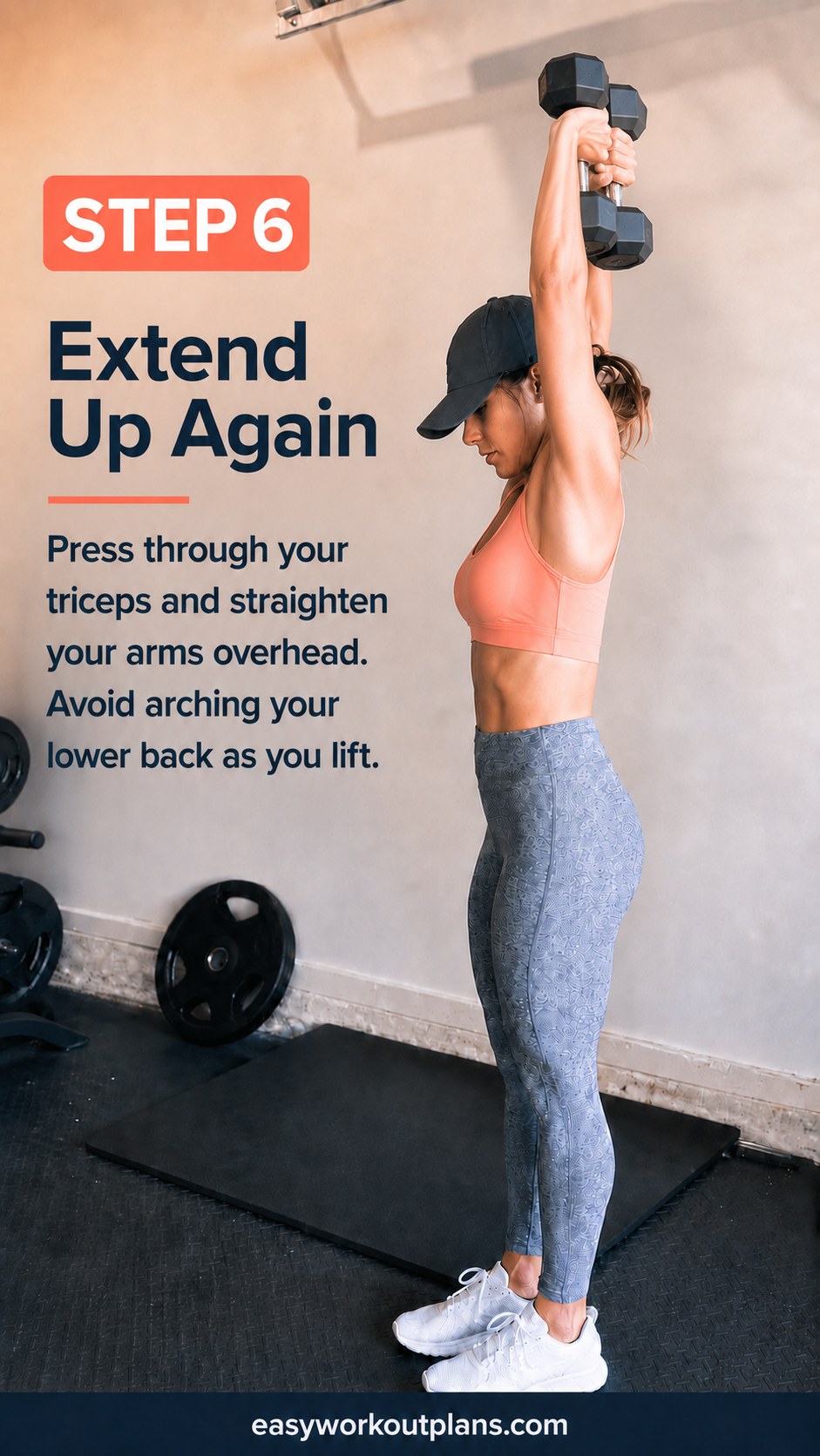 Extending the arms back overhead through the triceps to complete this dumbbell arm workout rep.