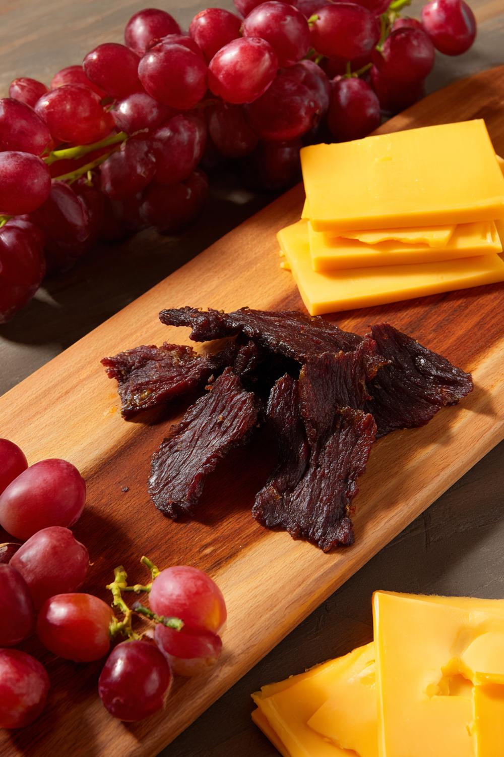 10. Beef Jerky Snack Board with Sharp Cheddar and Red Grapes